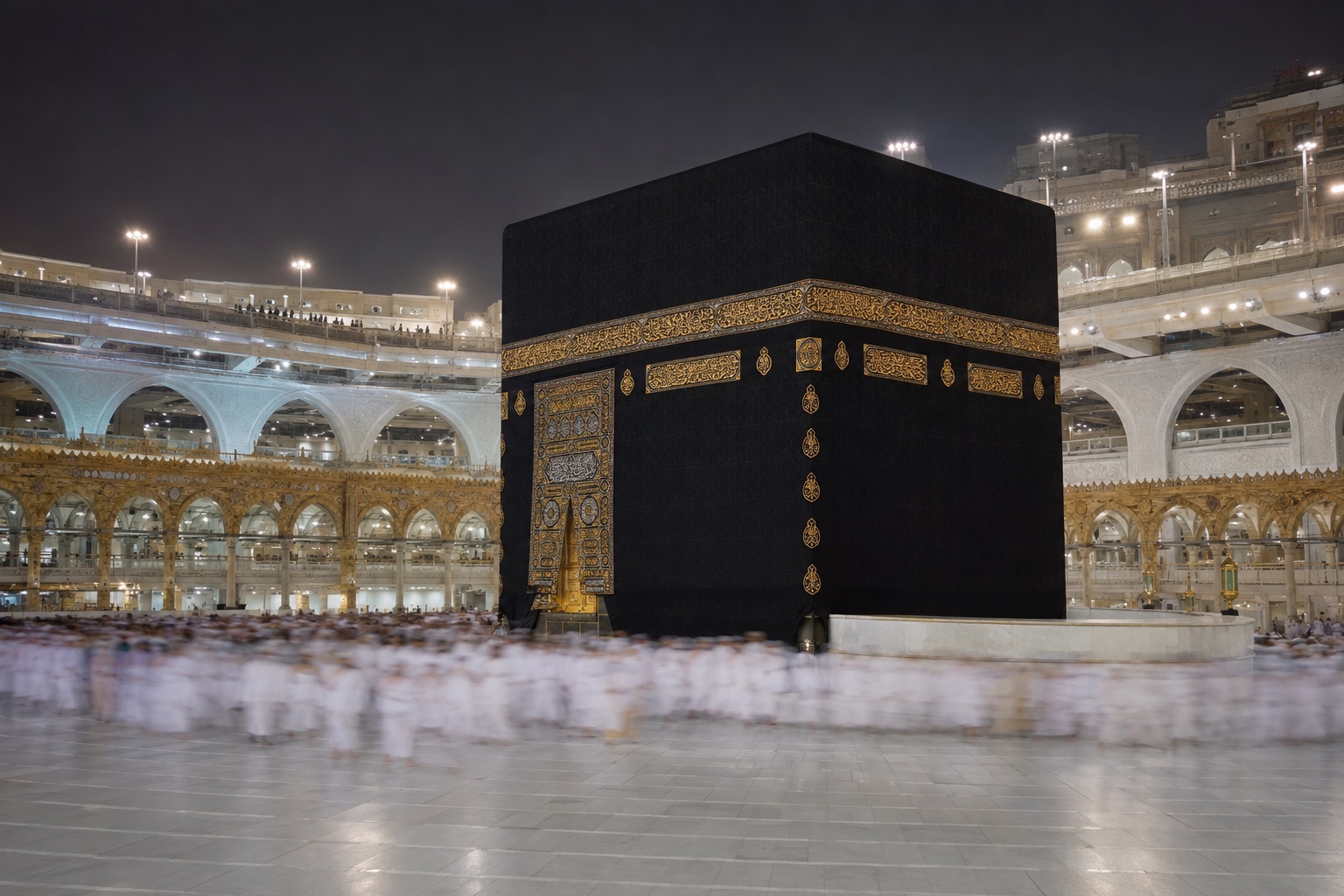 The Kaaba draped in its black Kiswah at the centre of the marble courtyard of Masjid al-Haram.